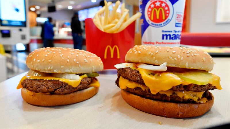 FILE- In this March 6, 2018, file photo, a McDonald's Quarter Pounder, left, and Double...