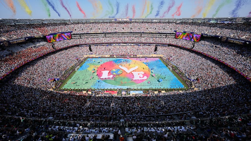 FILE -- Dancers perform as colorful smoke rises above the stadium during the halftime show at...