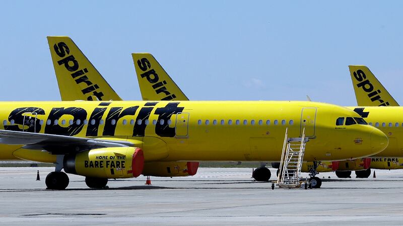 FILE - A line of Spirit Airlines jets sit on the tarmac at Orlando International Airport on...