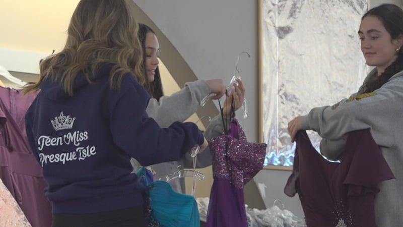 Volunteers sorting dresses for the Cinderella Project