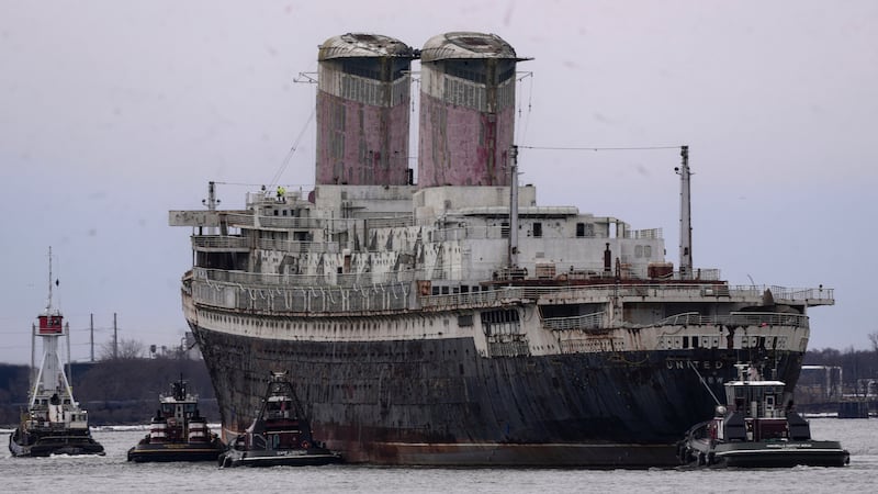FILE - The SS United States is towed down the Delaware River between Pennsylvania and New...