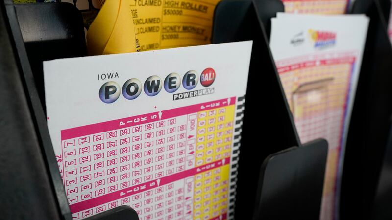 FILE - In this Jan. 12, 2021 file photo, blank forms for the Powerball lottery sit in a bin at...